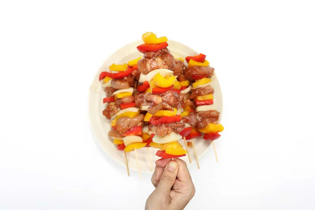 Raw chicken skewers on a plate