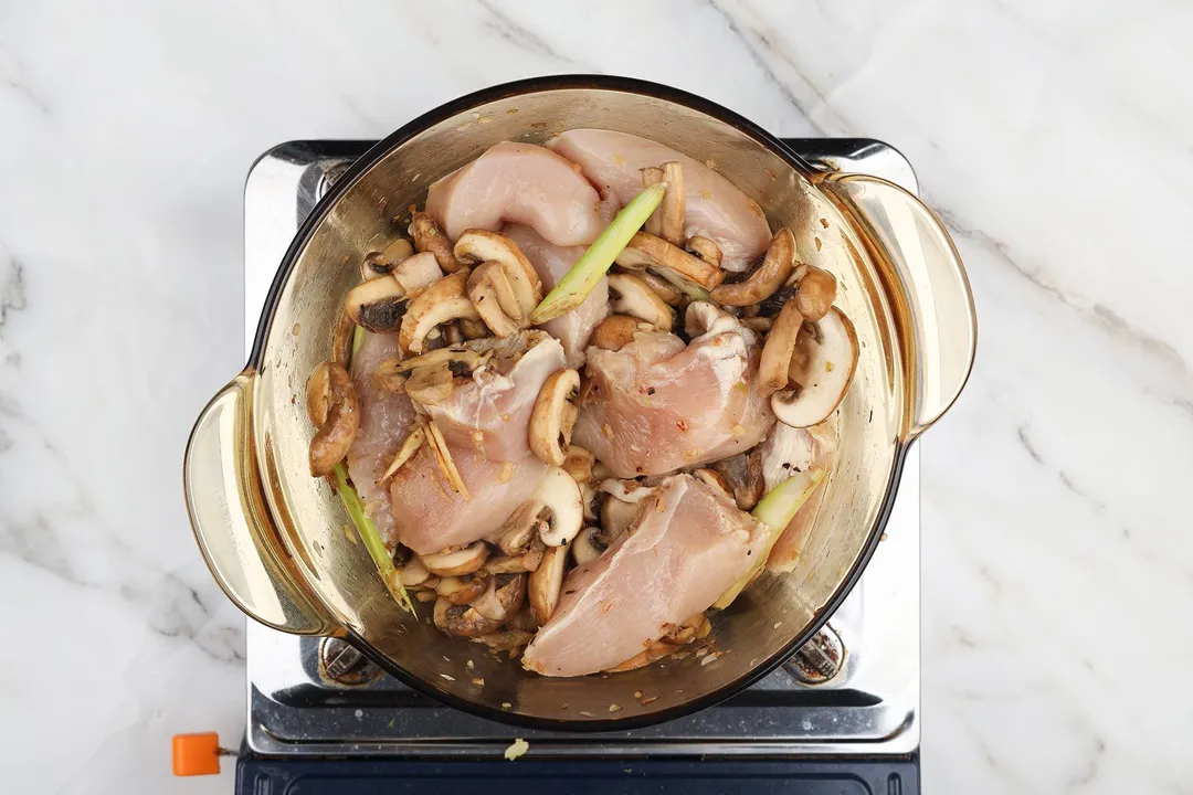 slices chicken breast cooking in a pot