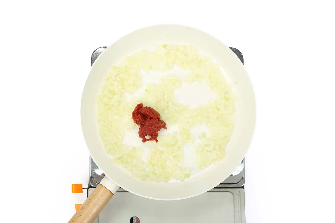 tomato paste and minced onion and garlic in a skillet