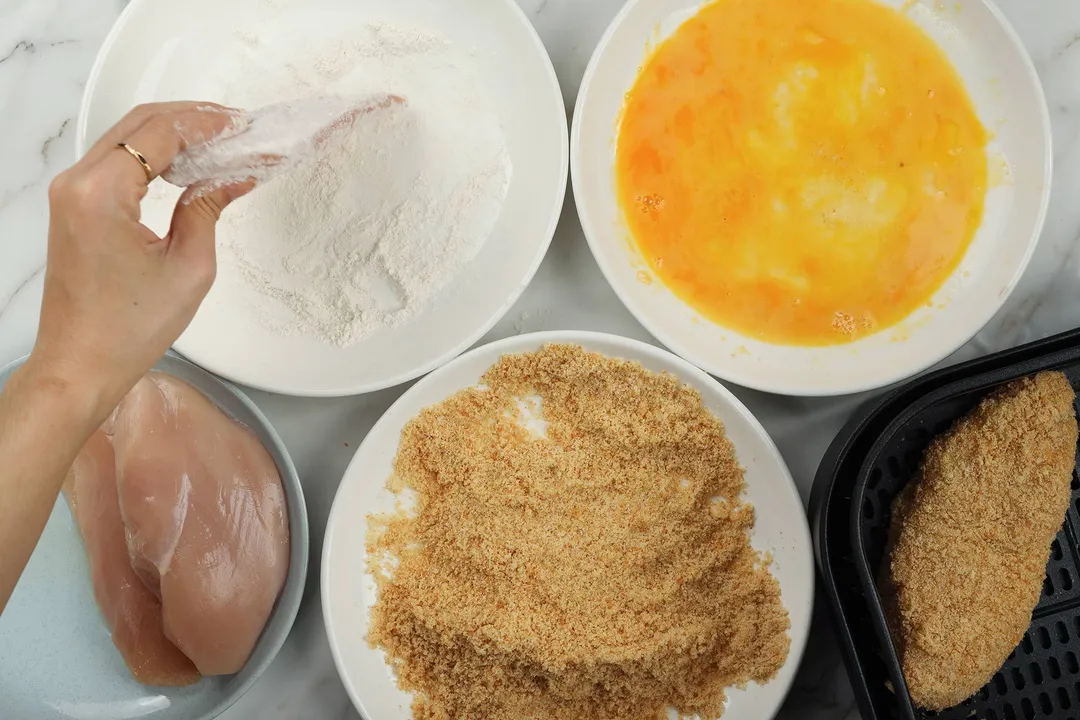 coating chicken breast in flour, beaten egg, breadcrumbs
