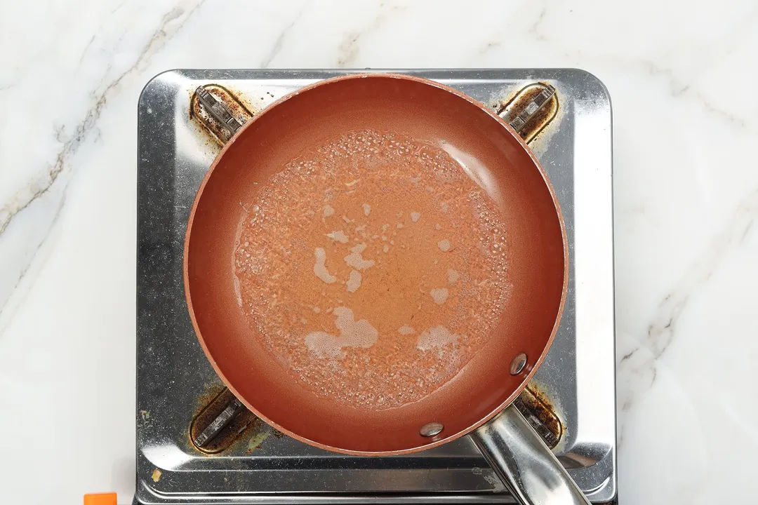 cooking sauce in a skillet on a stove