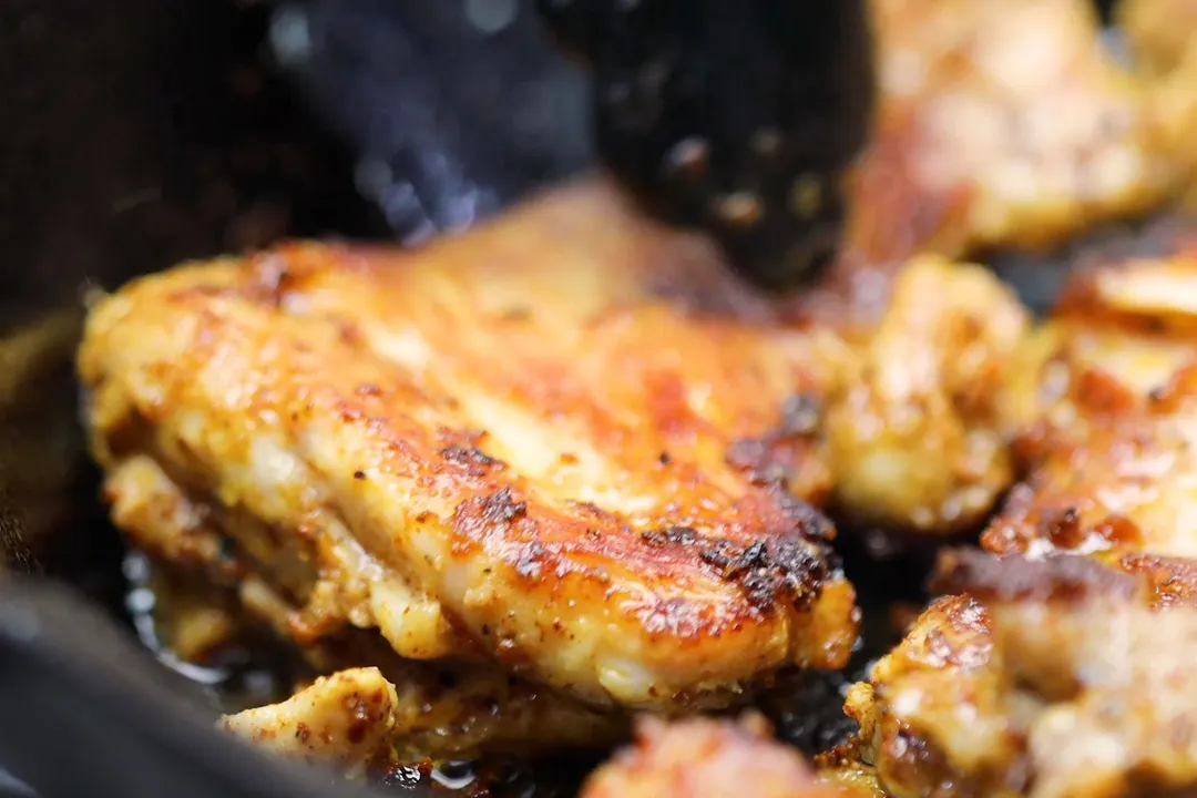 cooking chicken thighs in a skillet