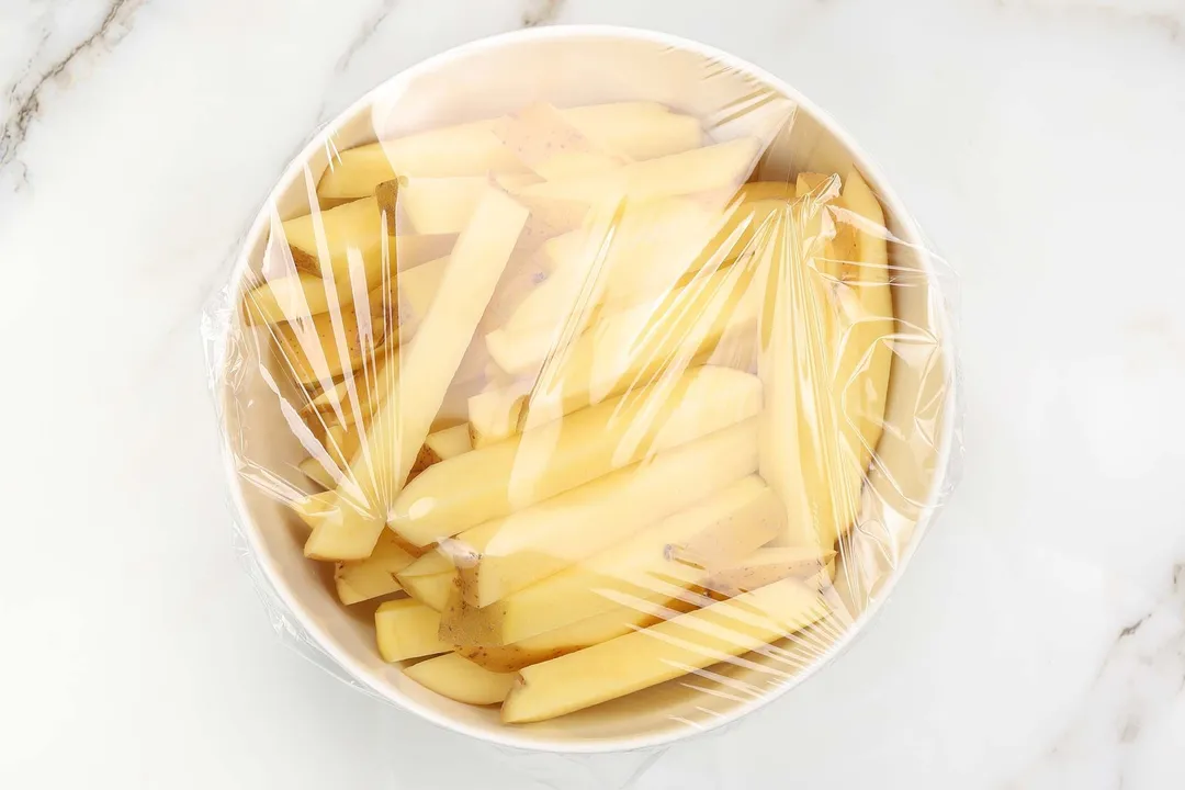 potato batonnet in a bowl covered by cling film