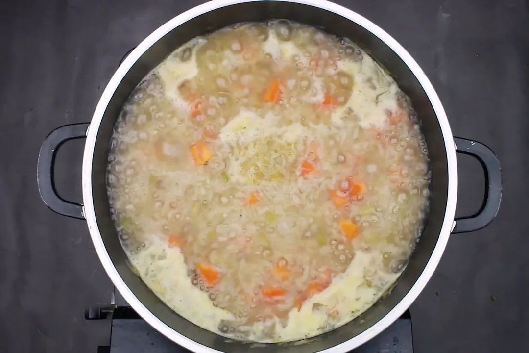 a pot of soup cooking on stove