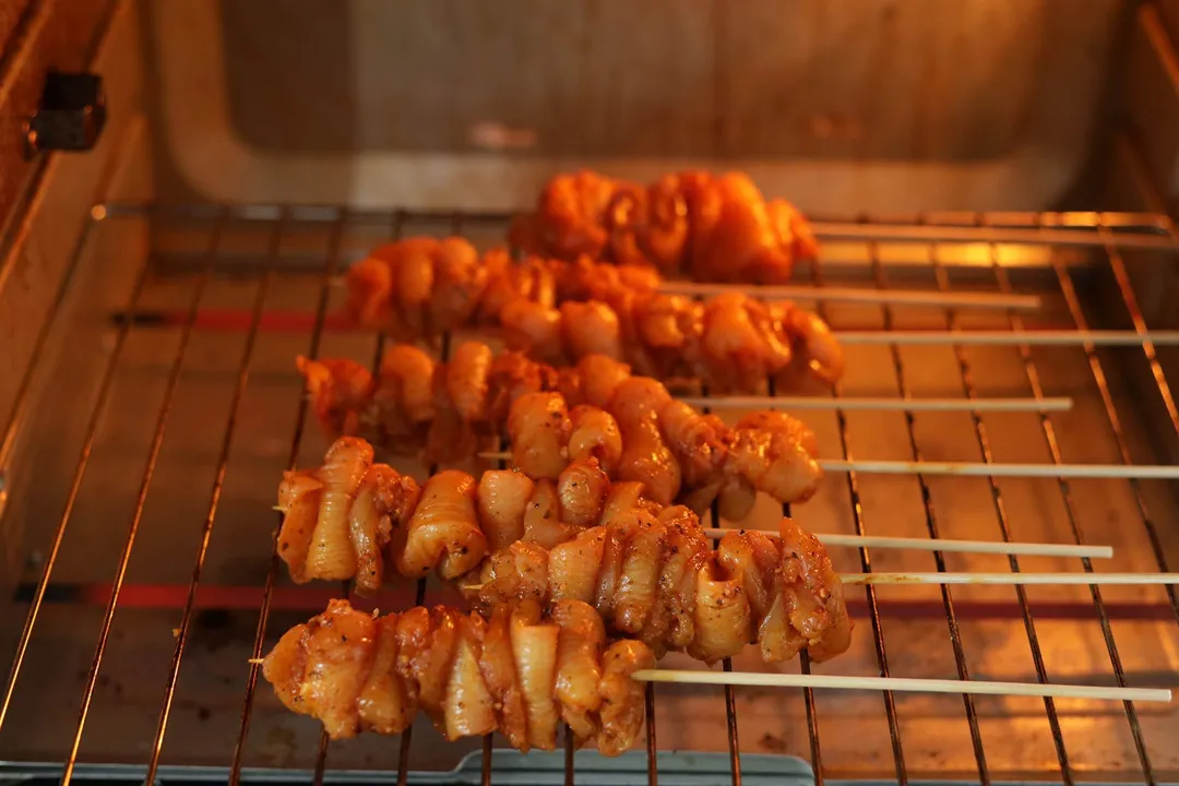 chicken in bamboo skewer baking in oven