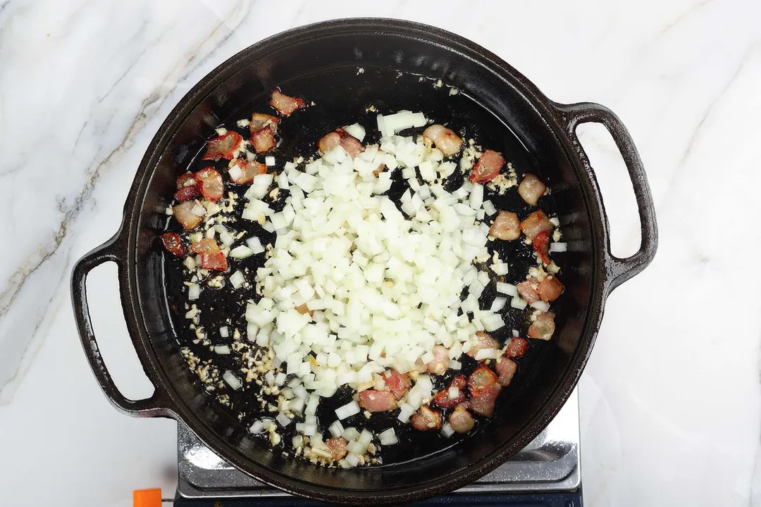 cooking chopped onion in a cast iron skillet