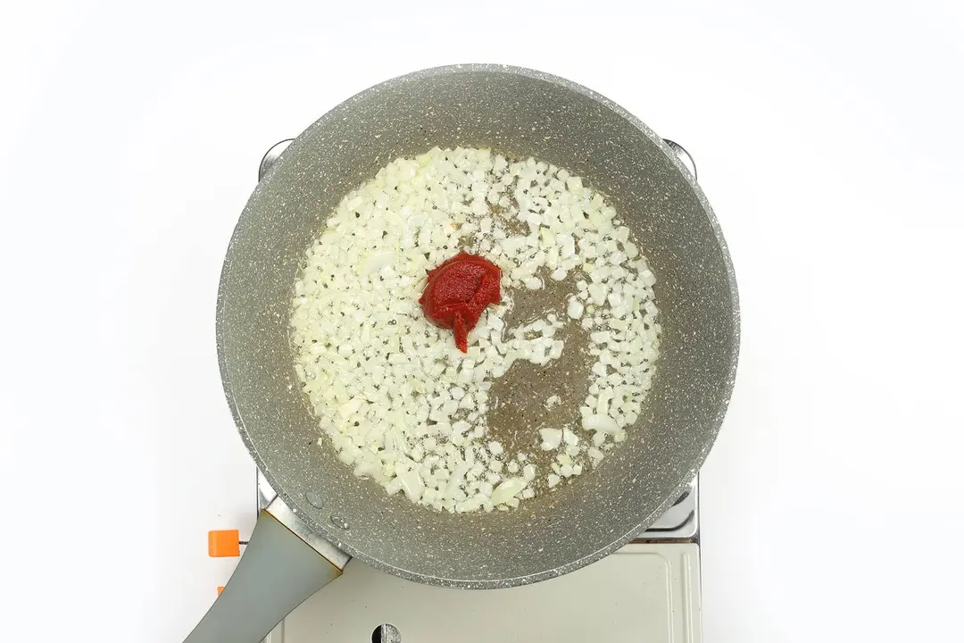 Garlic and tomato paste in a pan