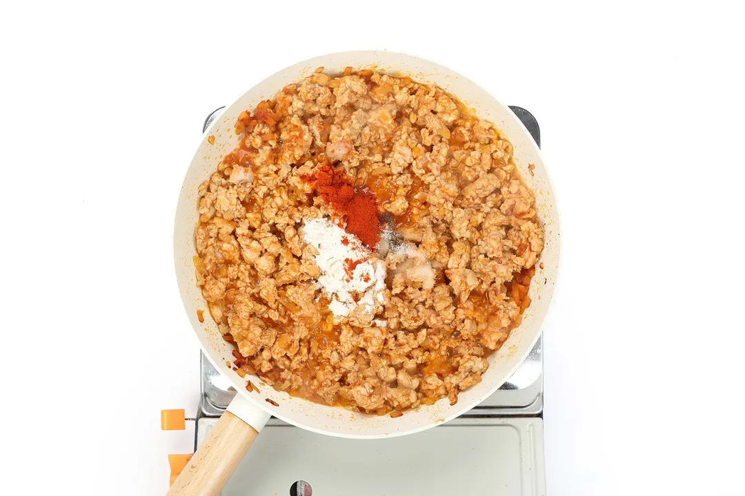 cooked ground chicken with spices in a skillet