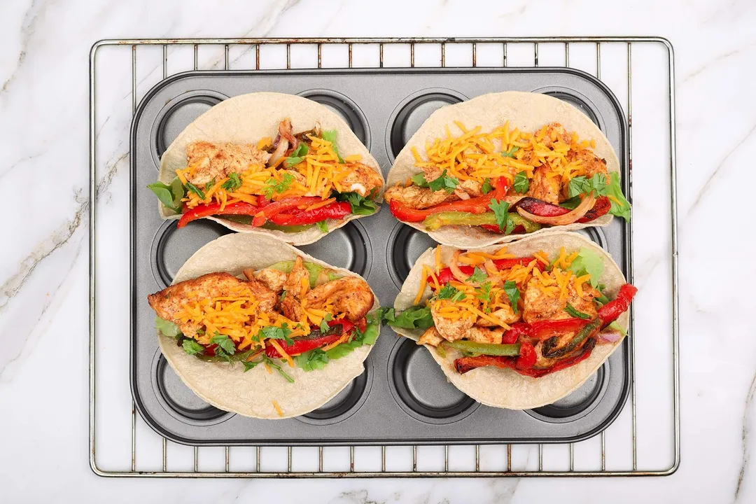 four tortillas of chicken fajitas with veggies and cheese