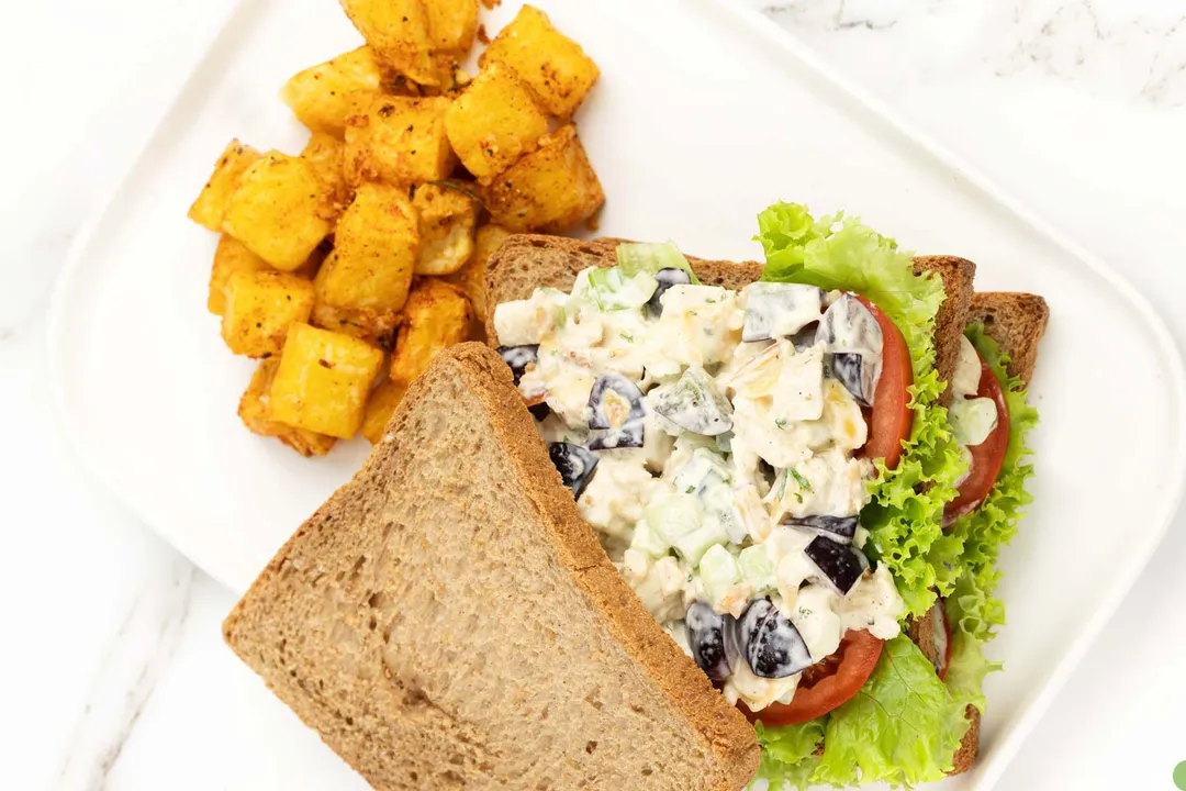 chicken salad and sandwich, home fries on a plate