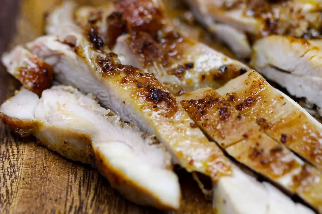 slices chicken thigh on a cutting board