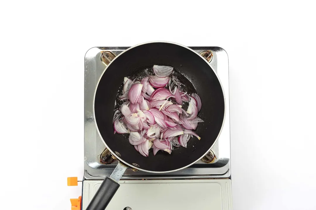 Raw shallots with oil in a pan