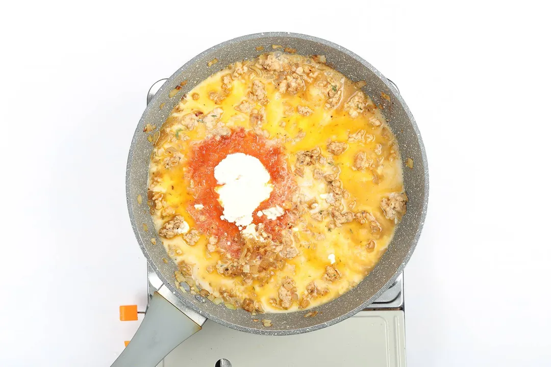 Ground chicken being cooked in tomato sauce