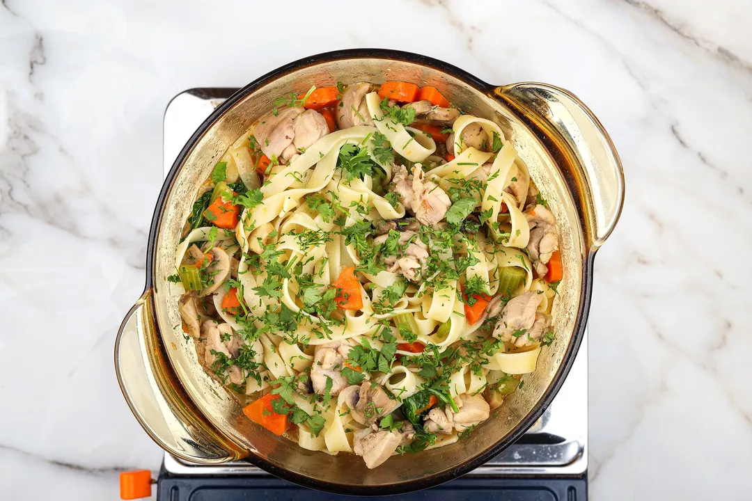 top view of a pot of cooked chicken noodle soup