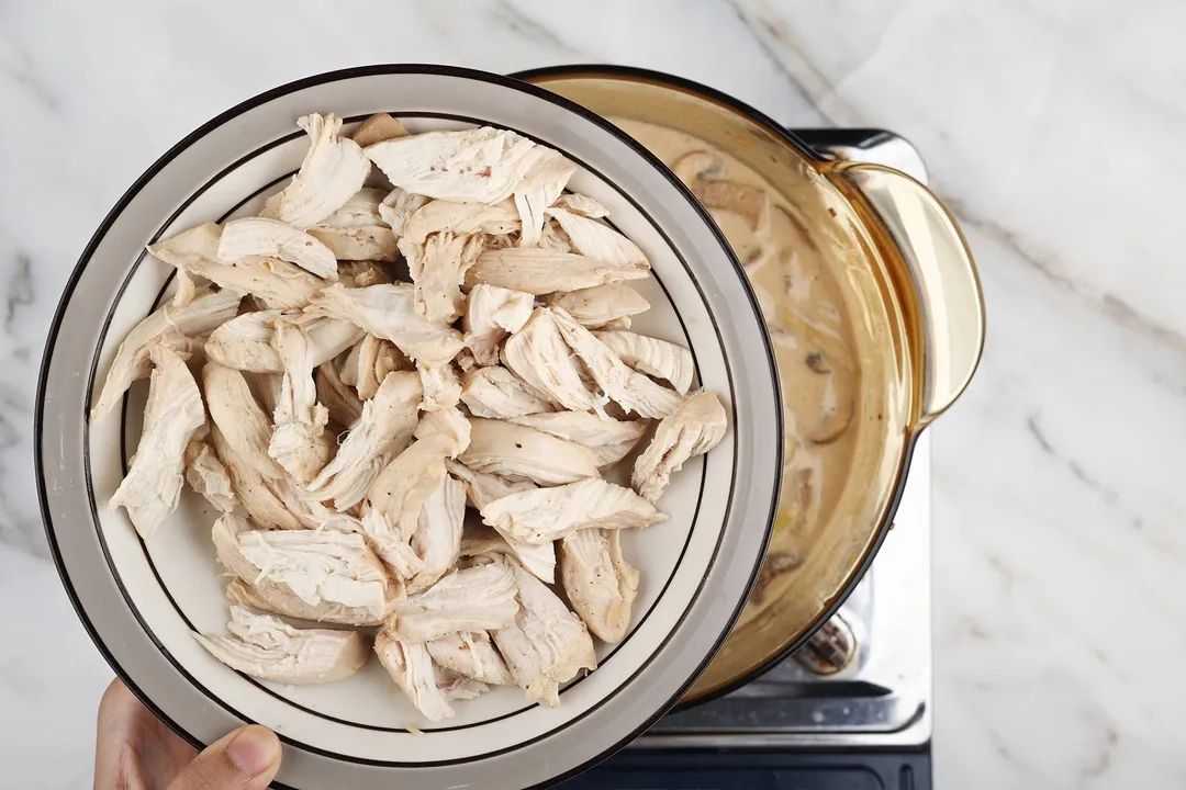 a plate of shredded chicken on top of a pot