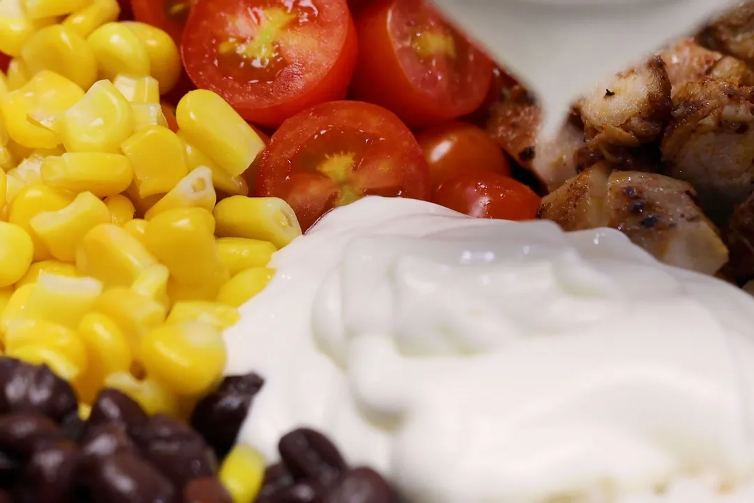 corn, dressing, half tomatoes and cooked chicken