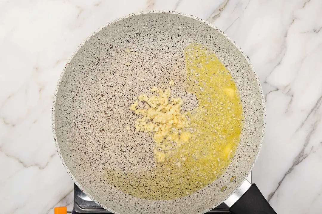 saute minced garlic and butter in a skillet