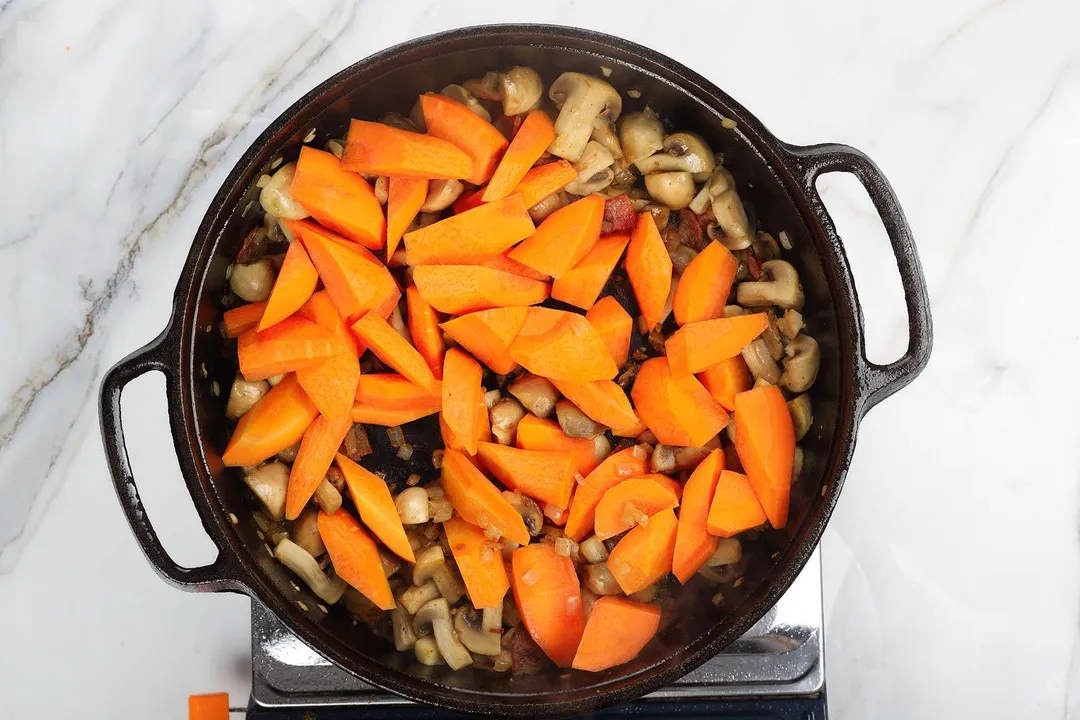 chopped carrots in a cast iron skillet
