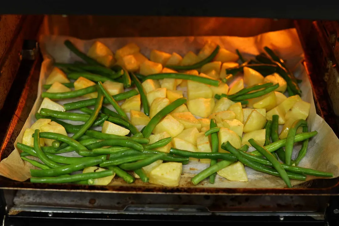 potato cubes and green beans in the oven
