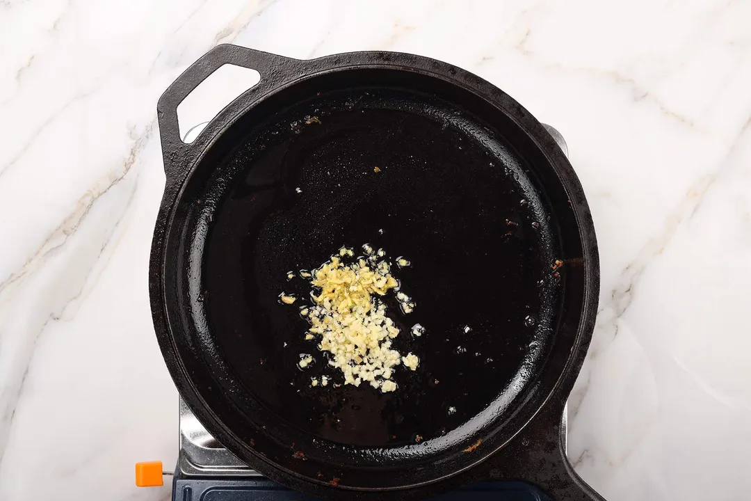 saute chopped garlic and ginger in a cast iron skillet