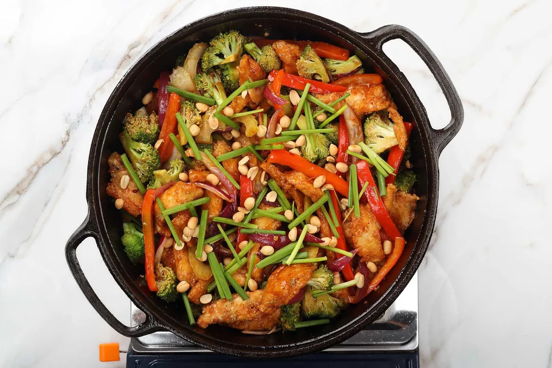 cooked chicken with vegetables in a cast iron skillet