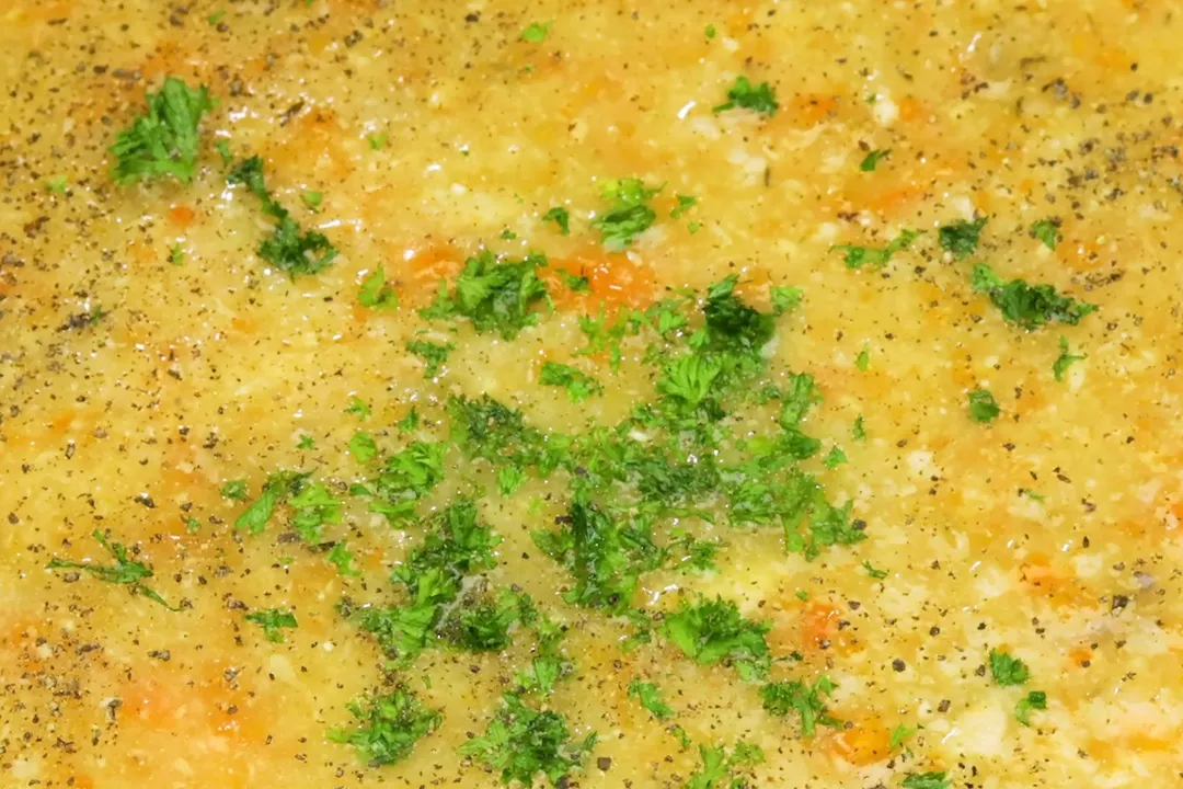 sprinkle parsley and ground black pepper on soup
