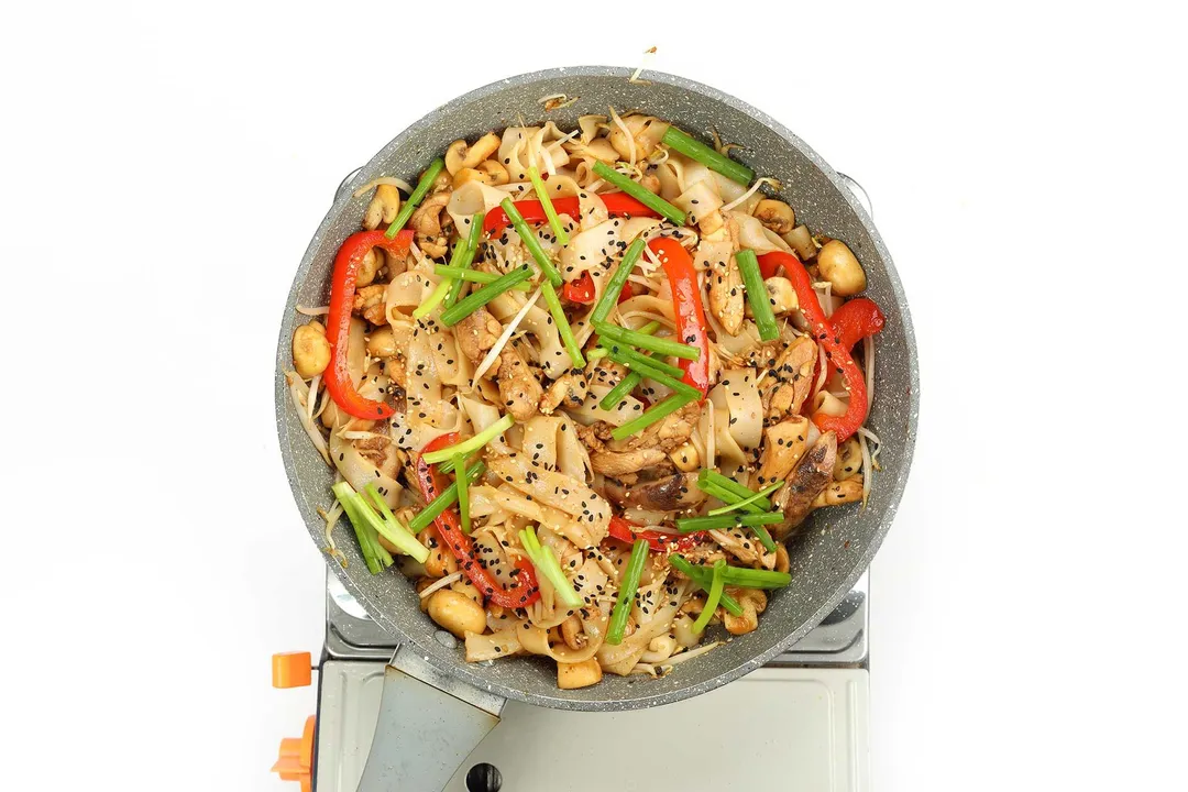 Cooked chicken chow fun in a pan