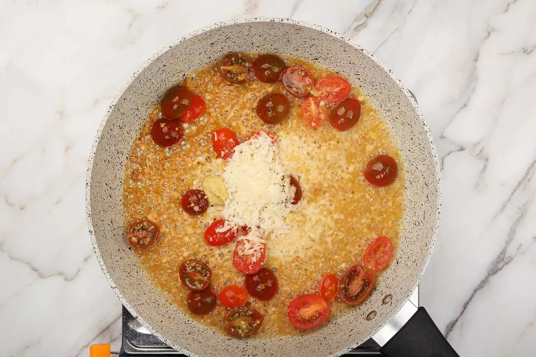 cheese, mustard and tomato cooking in a skillet