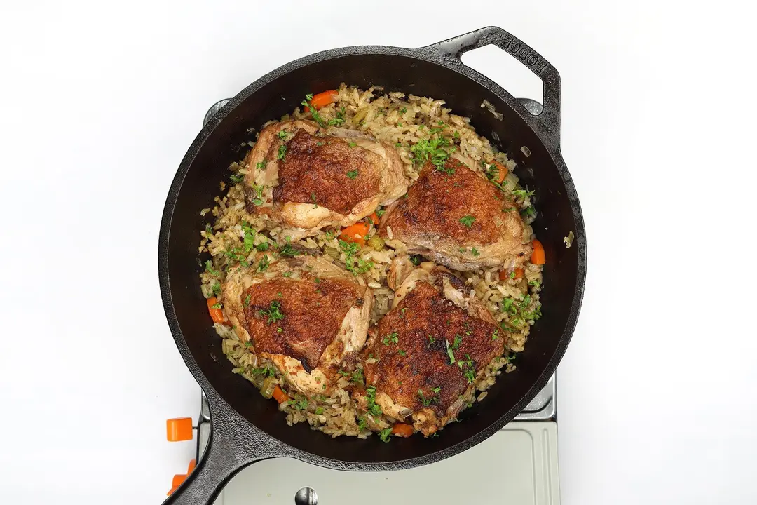 Cooked chicken rice in a cast iron skillet