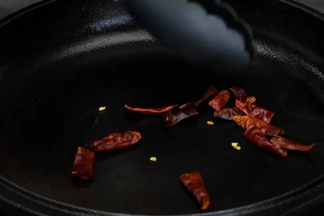 Tongs used to stir fry dried chilies for kung pao chicken