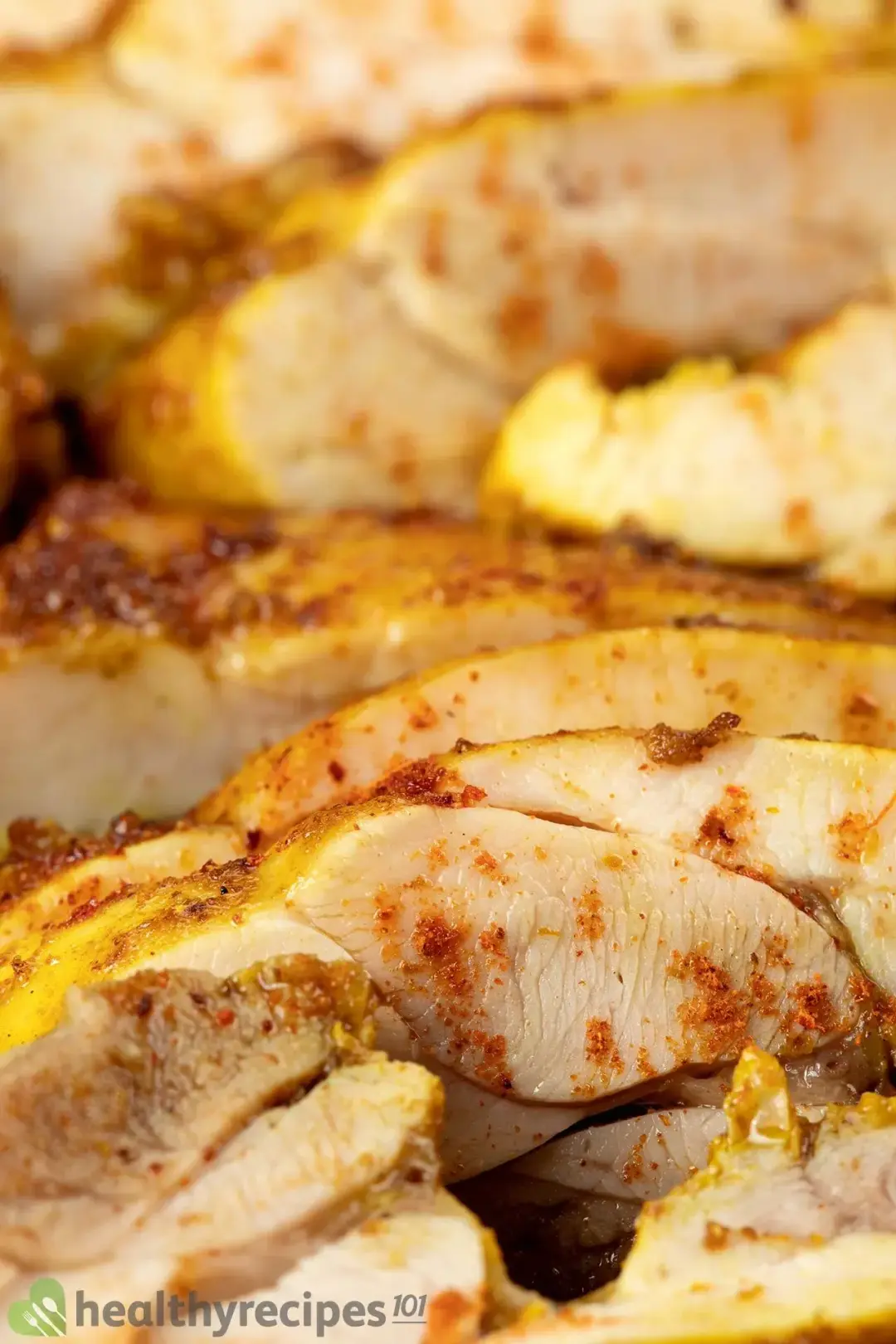 A close-up shot of cut-up chicken shawarma speckled with paprika