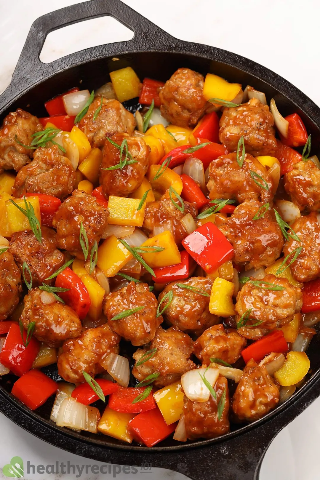 a cast iron skillet of cooked chicken manchurian