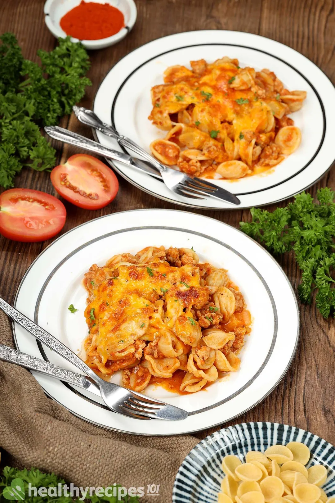 two plate of cooked ground chicken pasta casserole