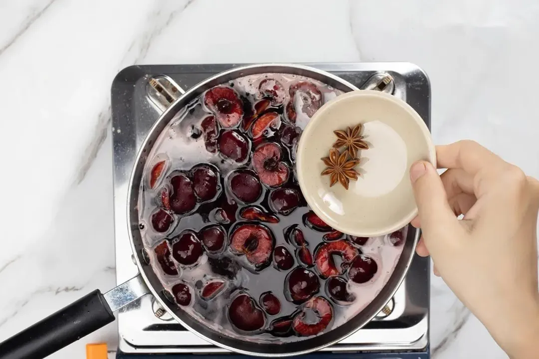 step 2 Add cherries cloves and vanilla bean paste