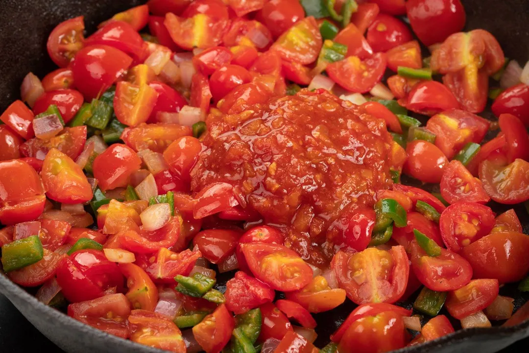 quartered tomatoes, sliced jalapeno, tomato sauce in a skillet