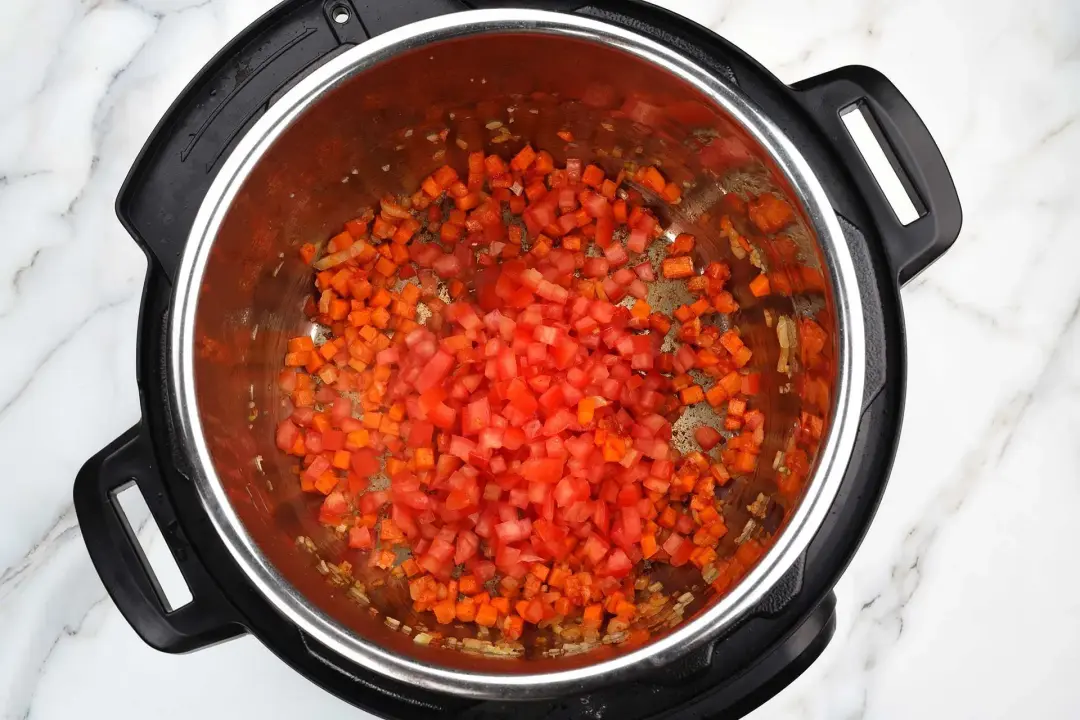 3 Add tomato paste and chopped tomatoes chili