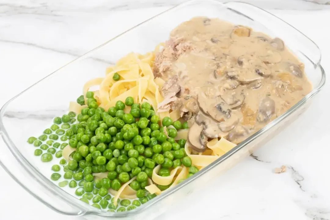 6 Mix noodles tuna peas milk gravy mix pepper cream of mushroom in the baking dish