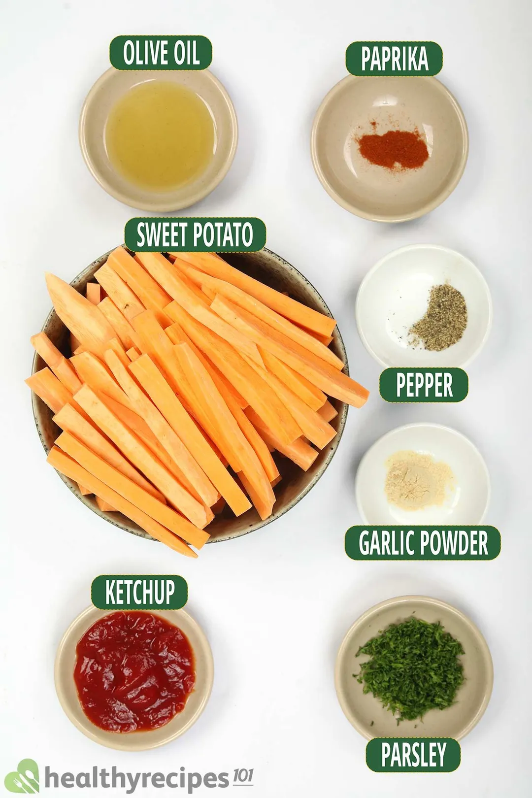 7 bowls of ingredients: olive oil, paprika, sweet potato sticks, ketchup...
