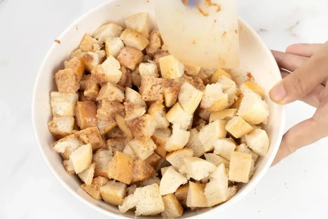 Cubed bread soaked with milk and spices in a bowl