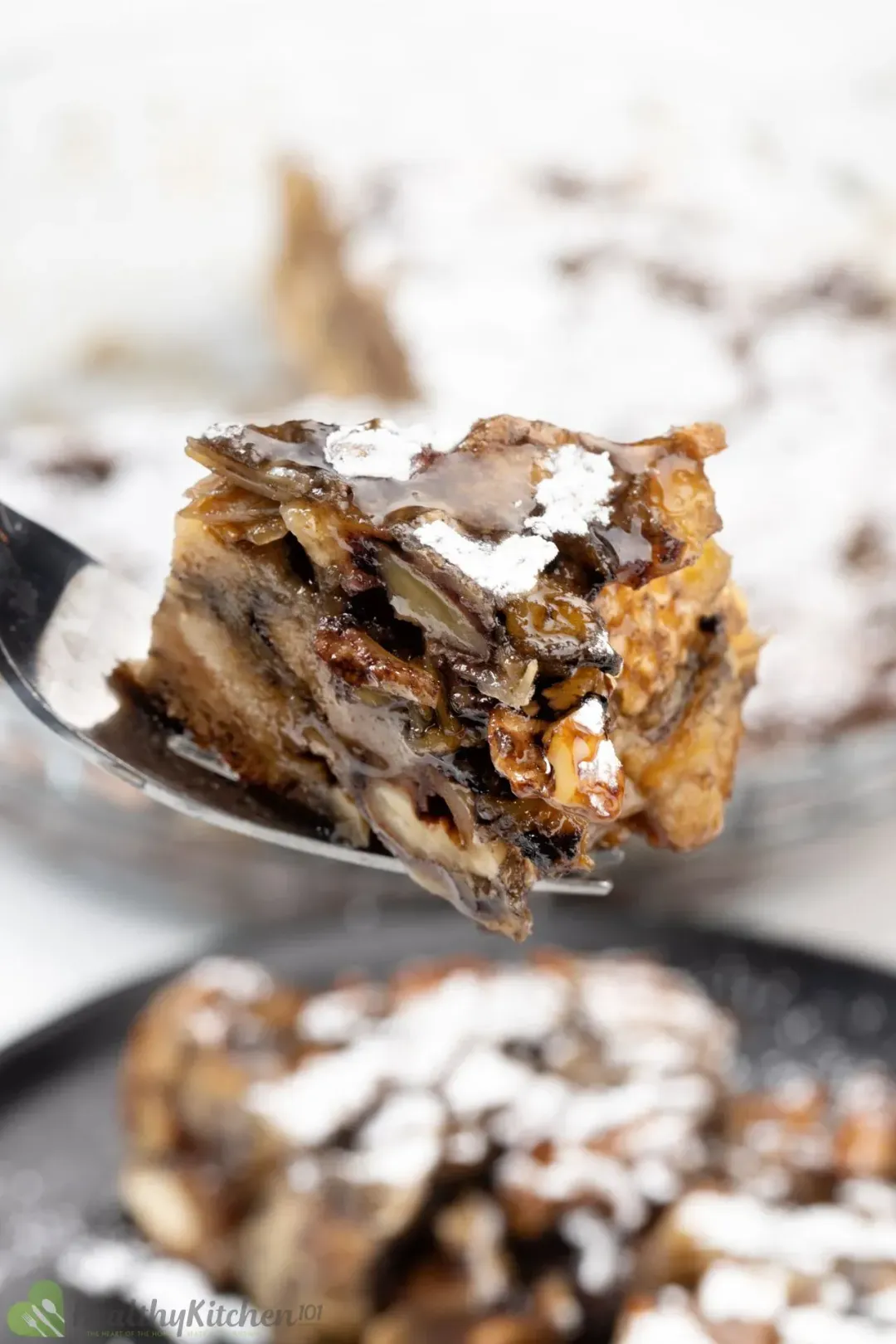 A piece of French toast casserole, with extra glossy maple syrup sauce