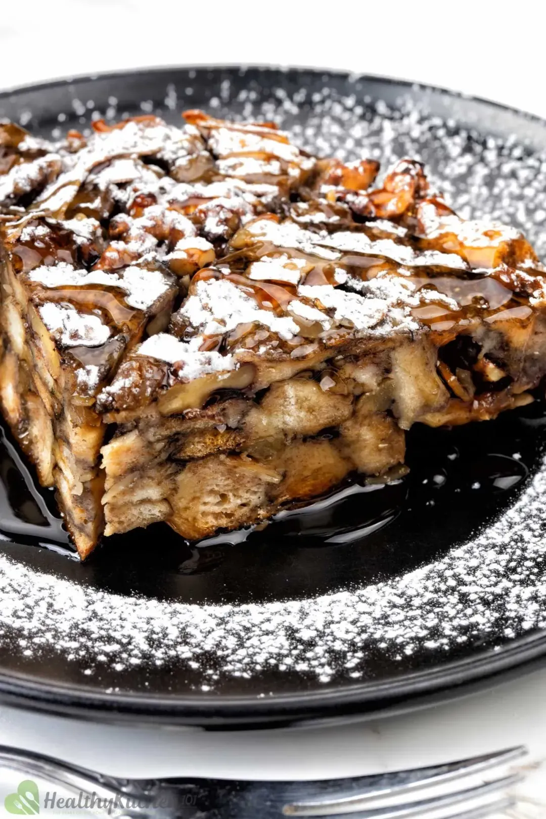 A quarter of a large french toast casserole topped with powdered sugar