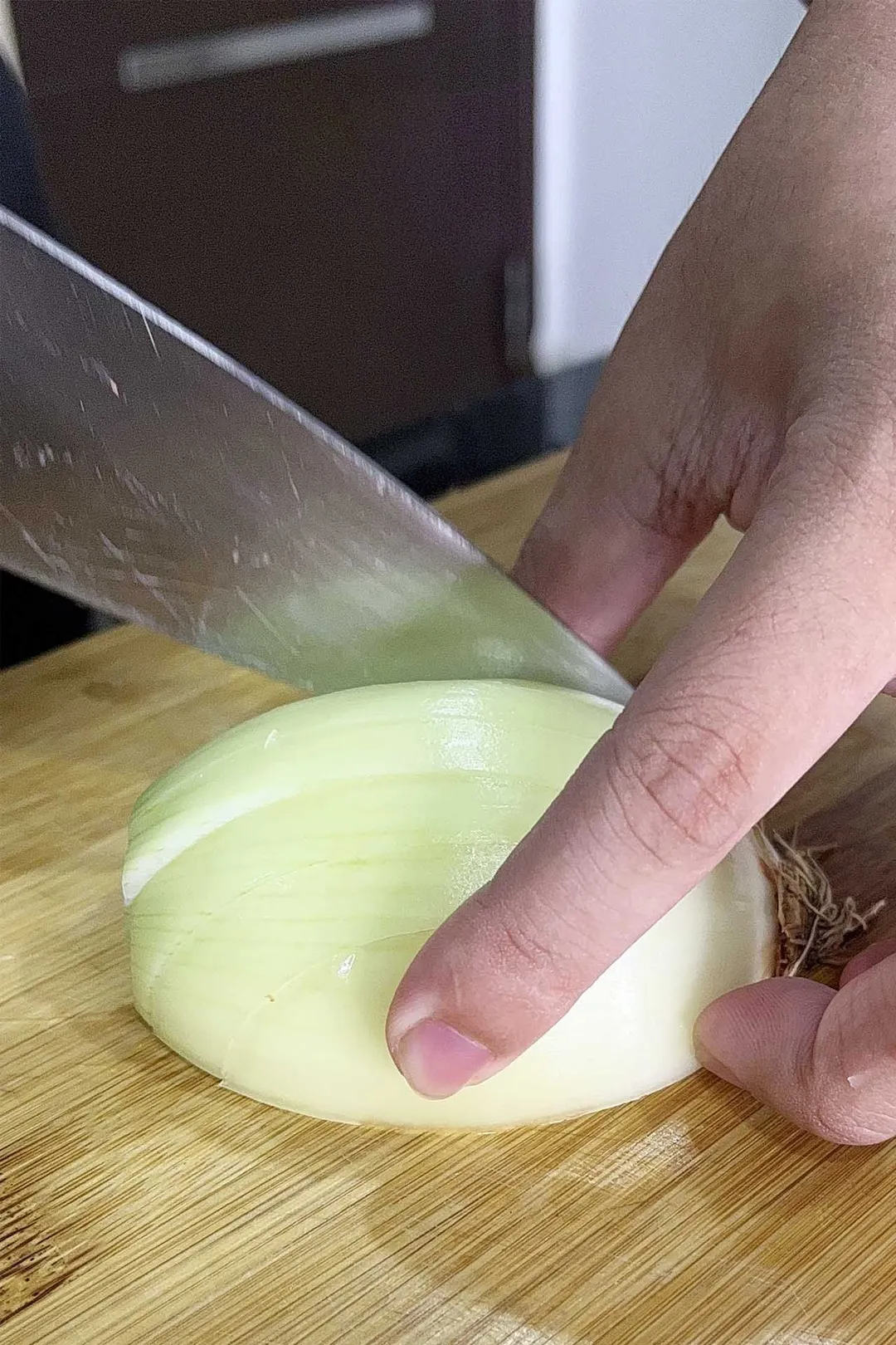chopping onion on a cutting board