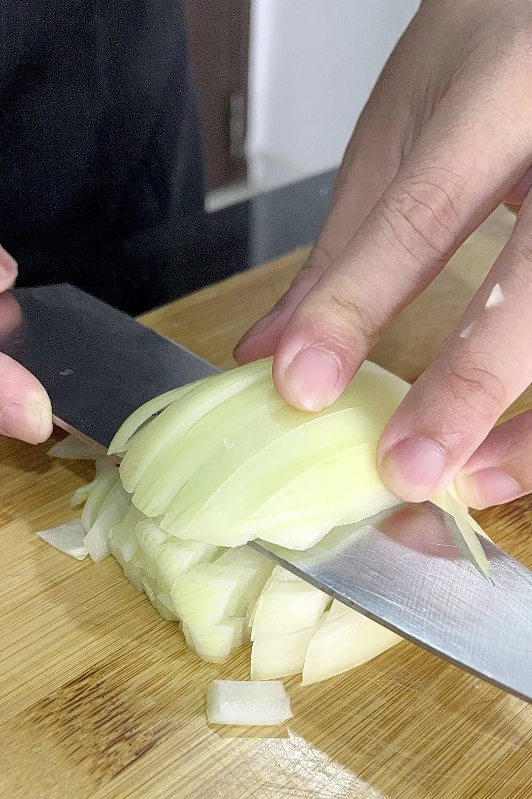 chopping a half onion on cutting board