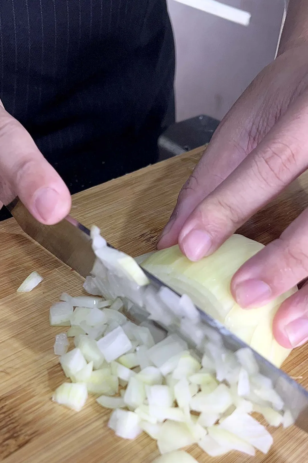 chopping onion on a cutting board