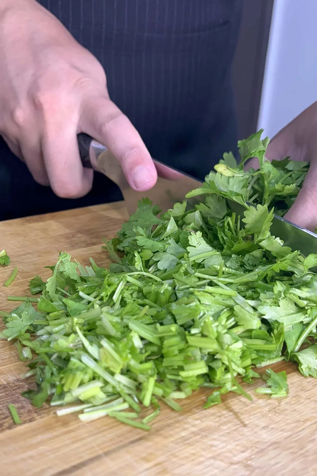 cutting cilantro on a cutting board