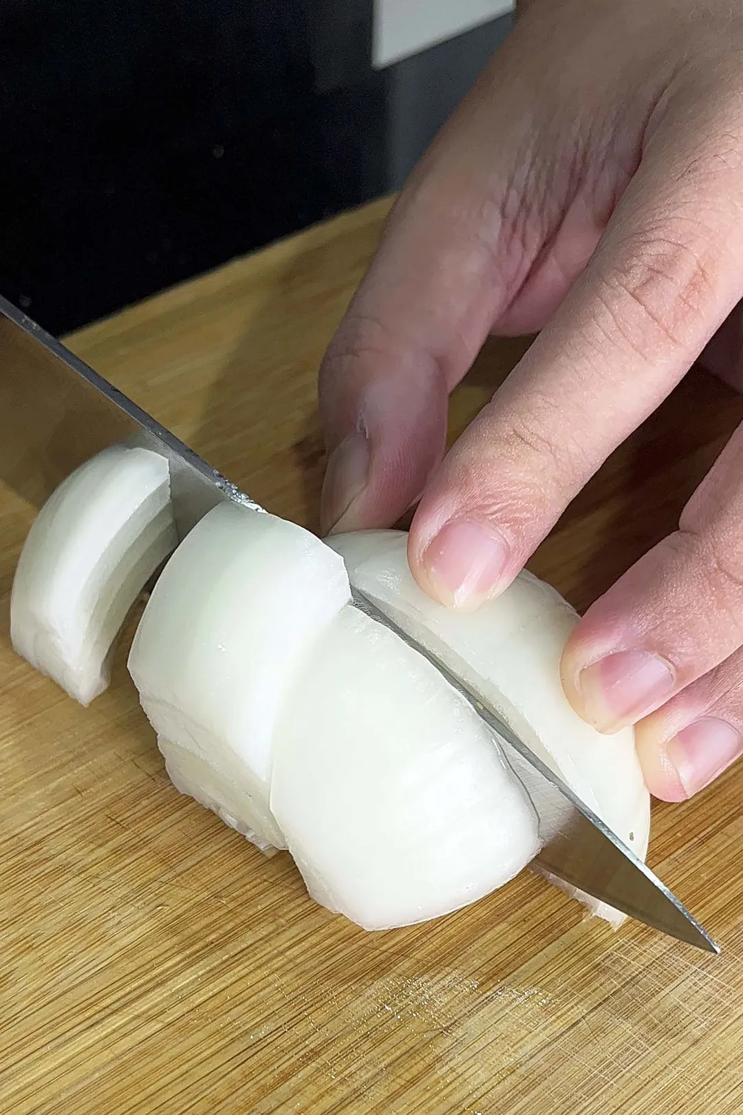 cutting onion on a cutting board
