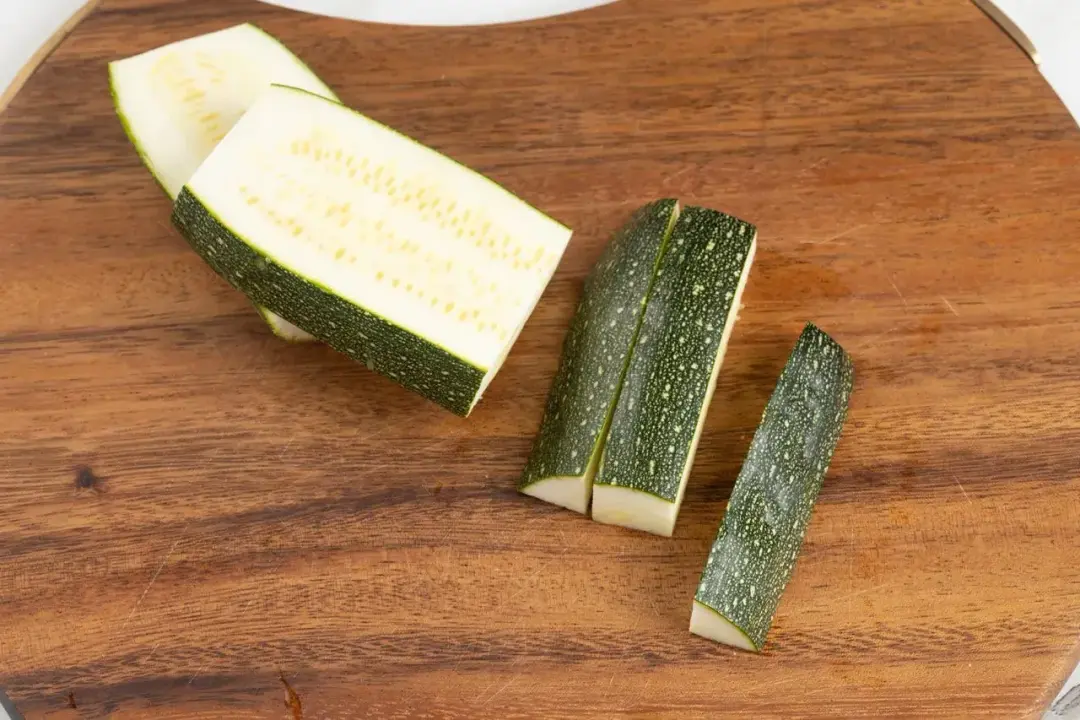 Pieces of zucchini on a wooden cutting board
