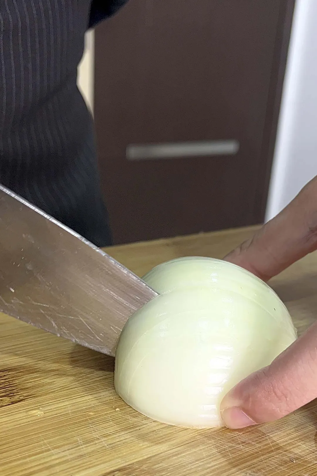 dice a half onion on a cutting board