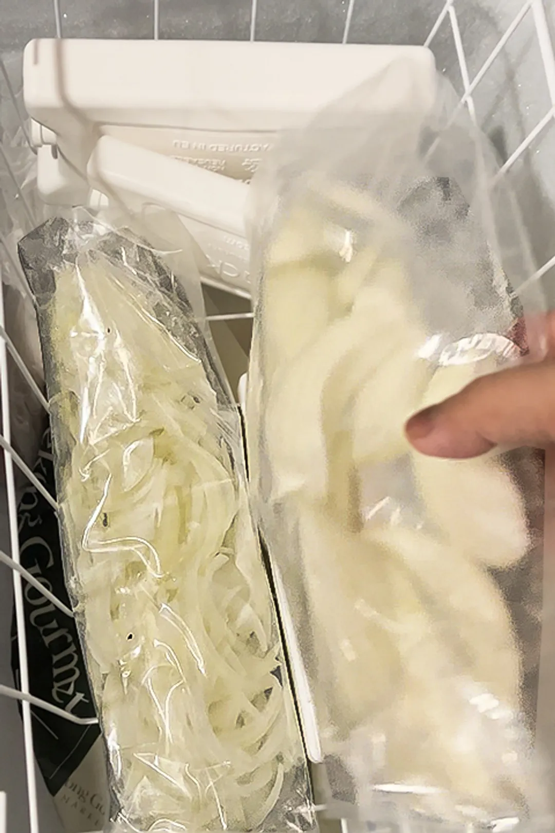 two bags of cut onions in a freeze