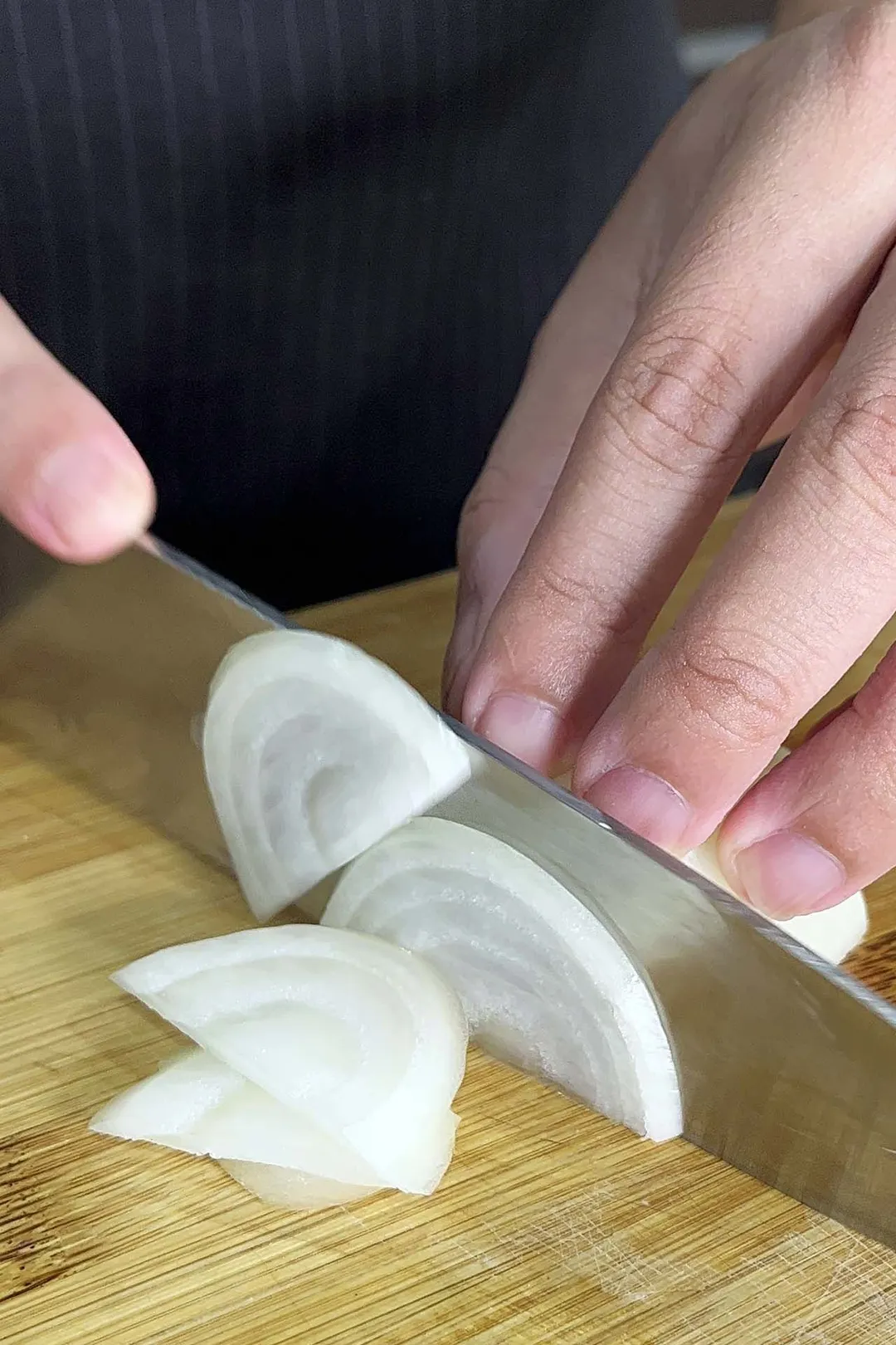 slicing onion on a cutting board